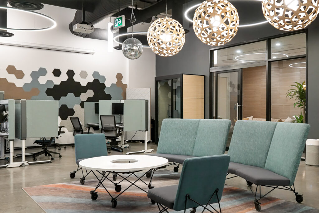 A lounge seating area at CAA Ottawa headquarters with SnapCab privacy pods in the background, providing a balanced space for collaboration and focus.
